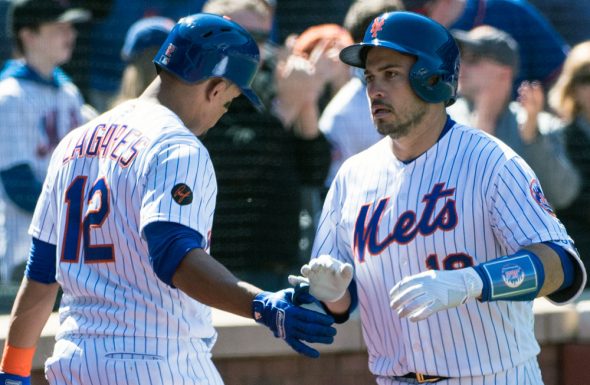 The new Rusty Staub memorial patch on the right sleeve of the jersey of Mets outfielder Juan Lagares as Travis d'Arnaud celebrates a home run on March 31, 2018 (Photo: Gregory J. Fisher-USA TODAY Sports)